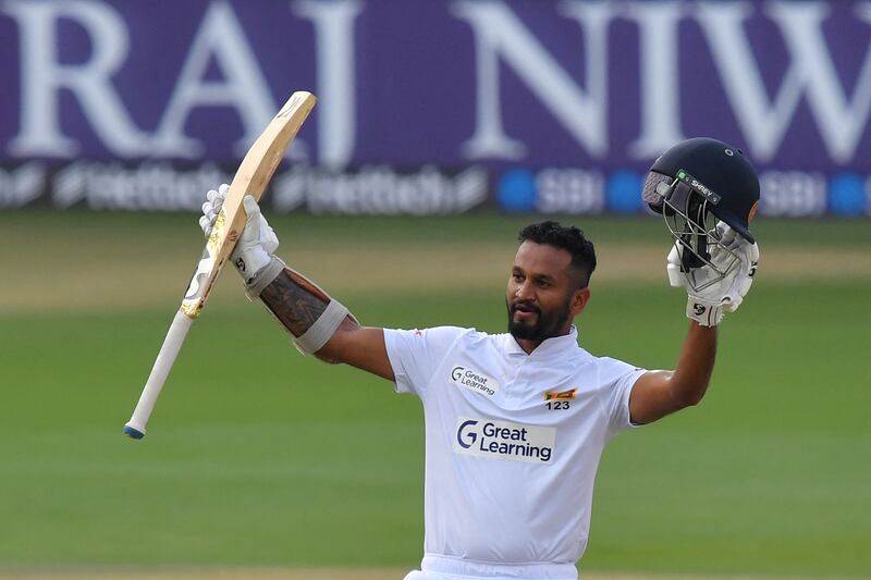 Sri Lanka's Dimuth Karunaratne celebrates after reaching his century. AFP