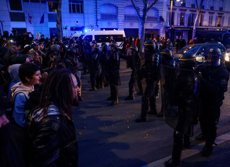 French riot officers face protesters at the Paris rally. Reuters