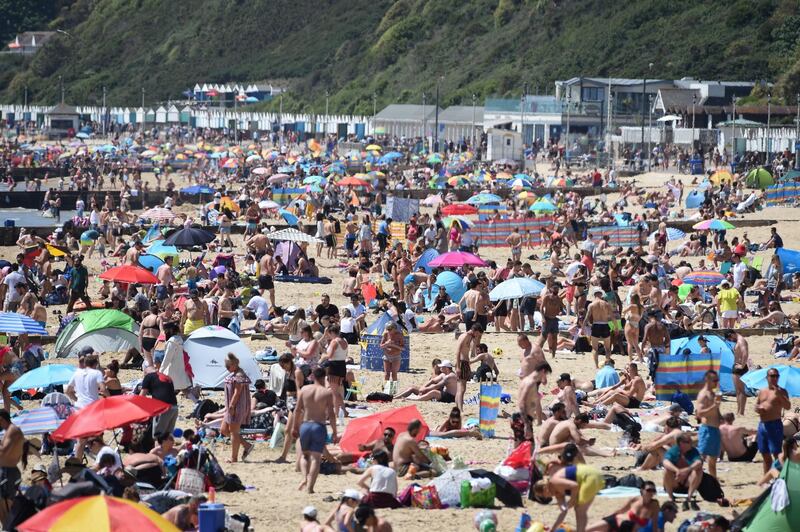 BOURNEMOUTH, ENGLAND - MAY 25: People enjoy the hot weather at Bournemouth beach during the UK's spring bank holiday on May 25, 2020 in Bournemouth, United Kingdom. The British government has started easing the lockdown it imposed two months ago to curb the spread of Covid-19, abandoning its  "stay at home" slogan in favour of a message to "be alert." But UK countries have varied in their approaches to relaxing quarantine measures.  (Photo by Finnbarr Webster/Getty Images)