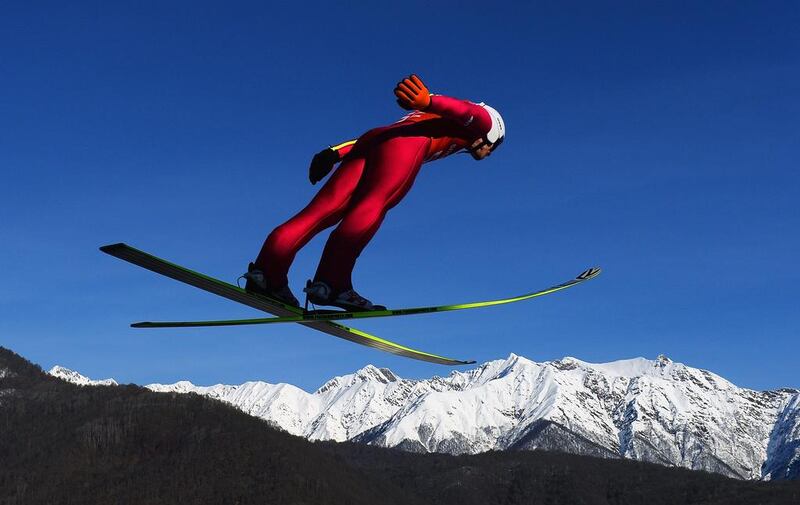 A ski jump athlete soars through the air during a training session on Friday.