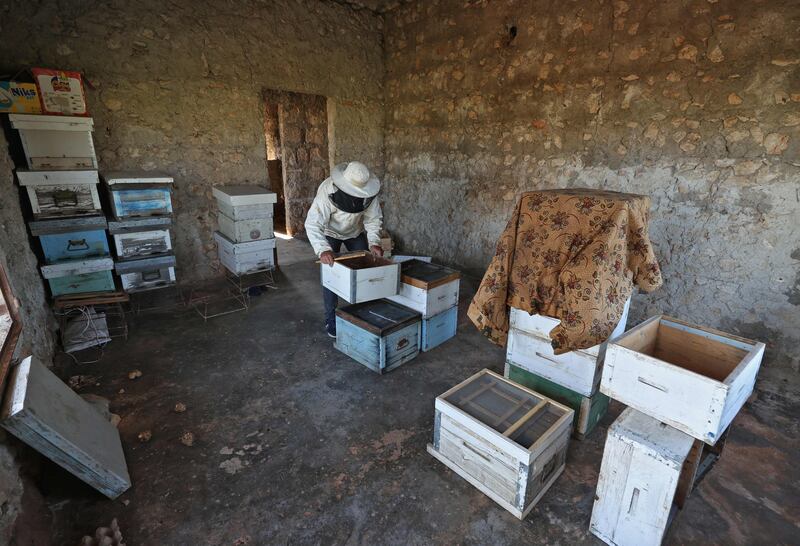 A Syrian beekeeper sorts honey. AFP