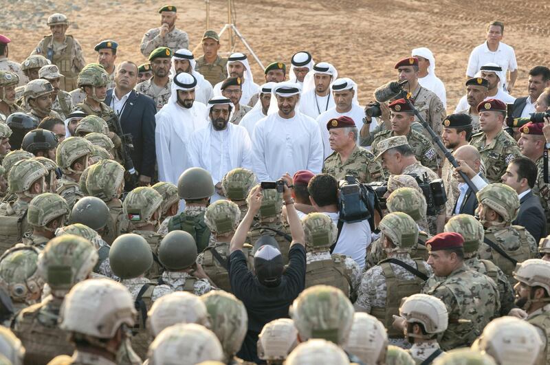 AL DHAFRA REGION, ABU DHABI, UNITED ARAB EMIRATES - June 26, 2019: HH Sheikh Mohamed bin Zayed Al Nahyan, Crown Prince of Abu Dhabi and Deputy Supreme Commander of the UAE Armed Forces (center 2nd R) and HM King Abdullah II, King of Jordan (center R), speaks with the UAE Armed Forcesand Jordanian Armed Forces, after the joint military drill, Titled ‘Bonds of Strength’, at Al Hamra Camp. Seen with HH Sheikh Tahnoon bin Mohamed Al Nahyan, Ruler's Representative in Al Ain Region (center 3rd R) and HH Sheikh Diab bin Tahnoon bin Mohamed Al Nahyan (center L).

( Hamad Al Mansouri for Ministry of Presidential Affairs )
---