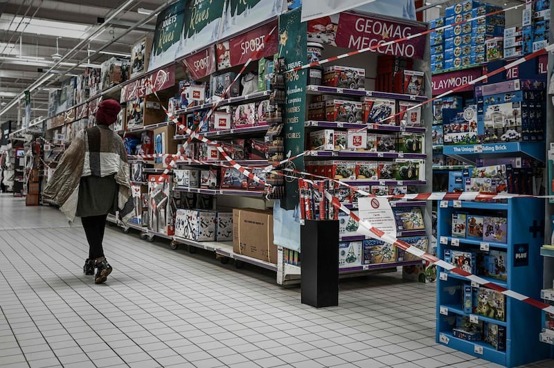 A customer walks past the closed toy department of a supermarket in Bordeaux, France. AFP