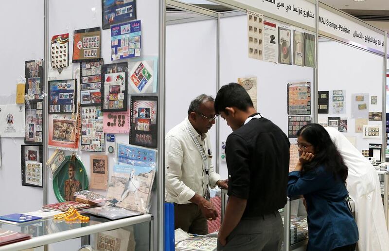 Visitors look at the vintage stamps and bank notes on display on November 11, 2016, at the stamp exhibition in Mega Mall in Sharjah. Pawan Singh / The National