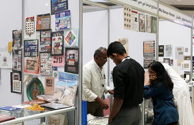 Visitors look at the vintage stamps and bank notes on display on November 11, 2016, at the stamp exhibition in Mega Mall in Sharjah. Pawan Singh / The National