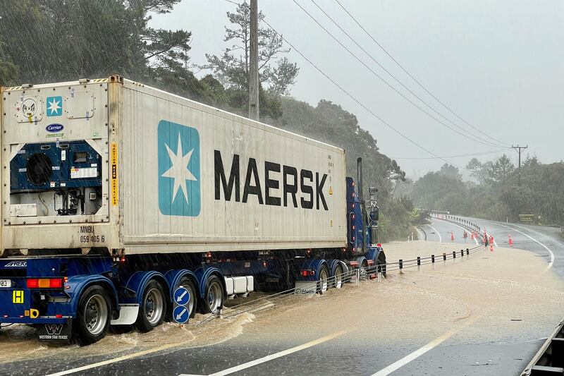 A truck is stopped by floodwater near Auckland. AP
