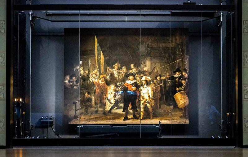 TOPSHOT - The remounted 1642 'Night Watch' is put in place at the Rijksmuseum Museum during 'Operation Night Watch',  the largest ever investigation into the painting by Dutch master Rembrandt in Amsterdam on June 22, 2021.   Using advanced technology the museum is able to determines how best to preserve the masterpiece for future generations.  - RESTRICTED TO EDITORIAL USE - MANDATORY MENTION OF THE ARTIST UPON PUBLICATION - TO ILLUSTRATE THE EVENT AS SPECIFIED IN THE CAPTION
 / AFP / ANP / Remko de Waal / RESTRICTED TO EDITORIAL USE - MANDATORY MENTION OF THE ARTIST UPON PUBLICATION - TO ILLUSTRATE THE EVENT AS SPECIFIED IN THE CAPTION
