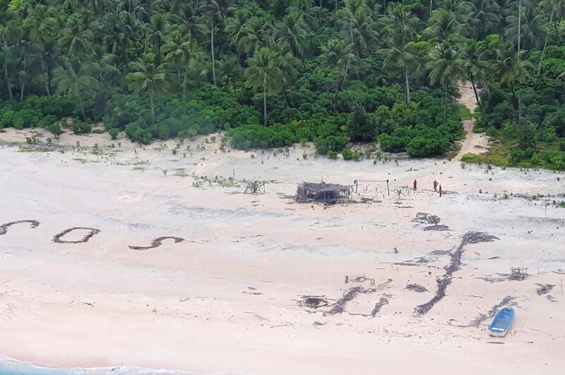 An Australian Army helicopter lands on Pikelot Island where three men were found safe and healthy after their giant SOS sign was spotted by warplanes. Australian Defence Force via AFP