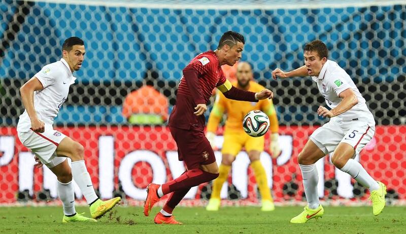 Portugal's Cristiano Ronaldo, centre, is closed down by United States' Matt Besler, right, and United States' Geoff Cameron last night. Paulo Duarte / AP Photo 