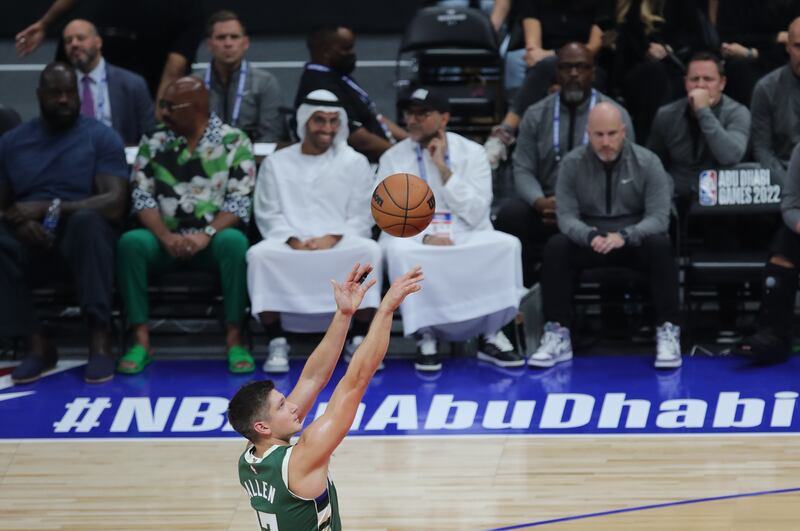 Left, Shaquille O'Neal and Steve Harvey look on as Grayson Allen of the Milwaukee Bucks takes a shot. EPA
