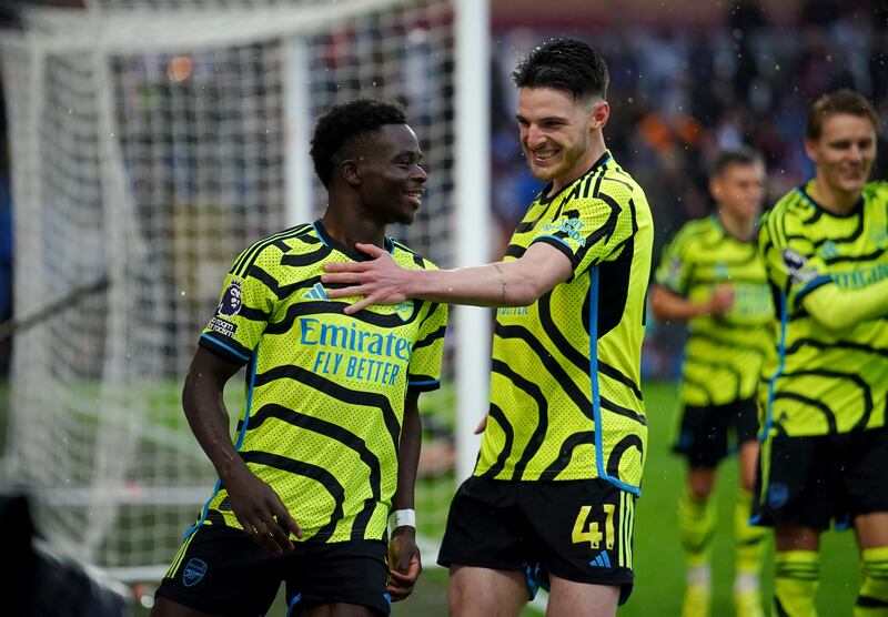 Arsenal's Bukayo Saka celebrates with Declan Rice after scoring his side's third goal against Burnley at Turf Moor on Saturday, February 17, 2024. PA