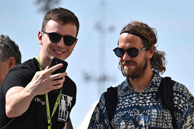 Aston Martin's German driver Sebastian Vettel poses for a selfie with a fan. AFP