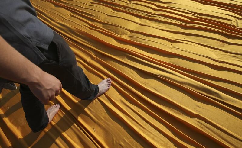 Khalid Altamini walks on the installation entitled The Floating Piers at the Iseo Lake. Luca Bruno / AP photo
