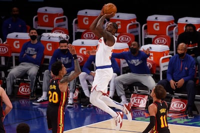 New York Knicks' Julius Randle (30) shoots in front of Atlanta Hawks' John Collins (20) and Trae Young (11) during the third quarter of an NBA basketball game Monday, Feb. 15, 2021, in New York. (AP Photo/Jason DeCrow, Pool)