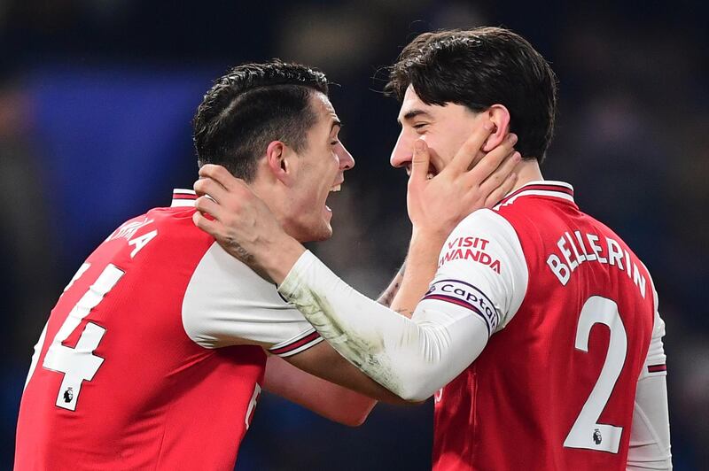 Arsenal's Granit Xhaka and Hector Bellerin celebrate getting a draw at Stamford Bridge. Getty