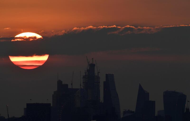 The sun rises behind skyscrapers in London, Britain. Toby Melville / Reuters