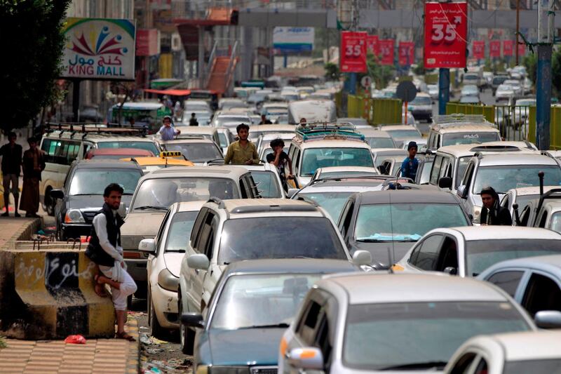 Yemeni drivers wait in line to refill their cars at a nearby petrol station in the capital Sanaa, on July, 9, 2020 amid fuel shortages. A fuel shortage is blighting life in the swathes of Yemen controlled by Huthi rebels, cutting electricity supplies, halting water pumps and stranding people in need of medical care as warring sides trade blame. Energy scarcity is nothing new in a country ravaged by years of conflict, but queues at the pumps have been getting longer by the day since mid-June.
 / AFP / MOHAMMED HUWAIS
