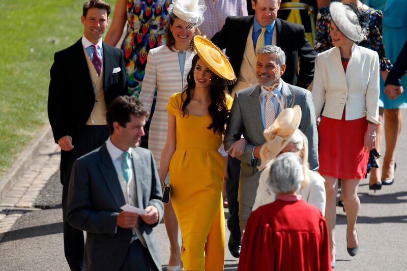 George Clooney and his wife Amal Clooney arrive for the wedding ceremony of Britain's Prince Harry and Meghan Markle at St George's Chapel, Windsor Castle, in Windsor. Odd Anderson / AFP