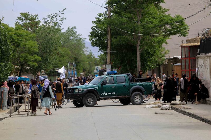 Taliban stand guard in an area surrounding a school in the aftermath of multiple bomb blasts in a Shi'ite majority neighborhood, in Kabul, Afghanistan. EPA