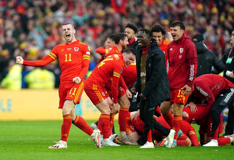 Gareth Bale (left) celebrates with his Wales team-mates after qualifying for the Qatar World Cup following victory in the  play-off final against Ukraine at Cardiff City Stadium. PA