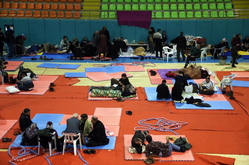 People rest at an indoor sports hall, a temporary shelter, after an earthquake hit Elazig, Turkey.  EPA