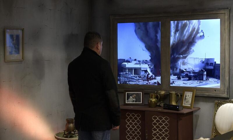 A man interacts with an installation by Amnesty International depicting a Syrian home during the war, in a passage of Buenos Aires’ subway.  On the LED screen, people can see as if through a window, the explosion of a bomb during the Syrian war. Juan Mabromata / AFP