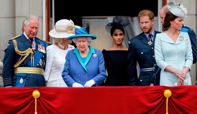 (FILES) In this file photo taken on July 10, 2018 (L-R) Britain's Prince Charles, Prince of Wales, Britain's Camilla, Duchess of Cornwall, Britain's Queen Elizabeth II, Britain's Meghan, Duchess of Sussex, Britain's Prince Harry, Duke of Sussex, Britain's Prince William, Duke of Cambridge and Britain's Catherine, Duchess of Cambridge, and come onto the balcony of Buckingham Palace to watch a military fly-past to mark the centenary of the Royal Air Force (RAF). Britain's Queen Elizabeth II on January 13, 2020, said Prince Harry and his wife Meghan would be allowed to split their time between Britain and Canada while their future is finalised. The couple said last week they wanted to step back from the royal frontline, catching the family off guard and forcing the monarch to convene crisis talks about the pair's future roles. / AFP / Tolga AKMEN
