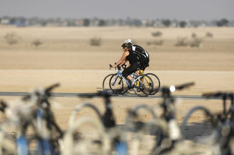 Cyclists at Al Qudra Cycle Track in Dubai. Several more cycling tracks are in the pipeline for residential areas. Sarah Dea / The National 