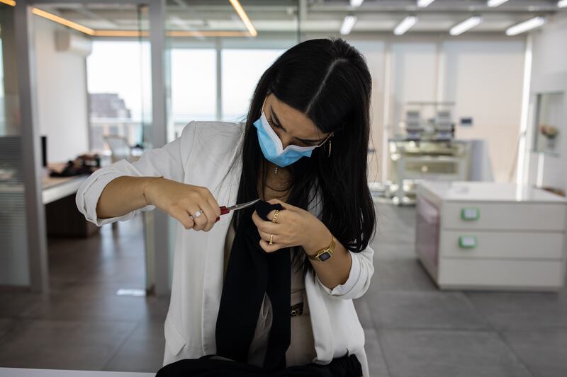 Stephanie Rizk carries out some quality control on a pair of trousers.