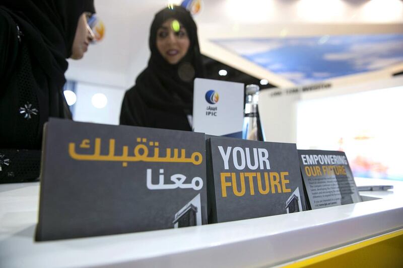 Emirati nationals peruse the exhibition near the Ipic stand at Tawdheef, a job fair open to UAE citizens only at the Abu Dhabi National Exhibition Center. Silvia Razgova / The National