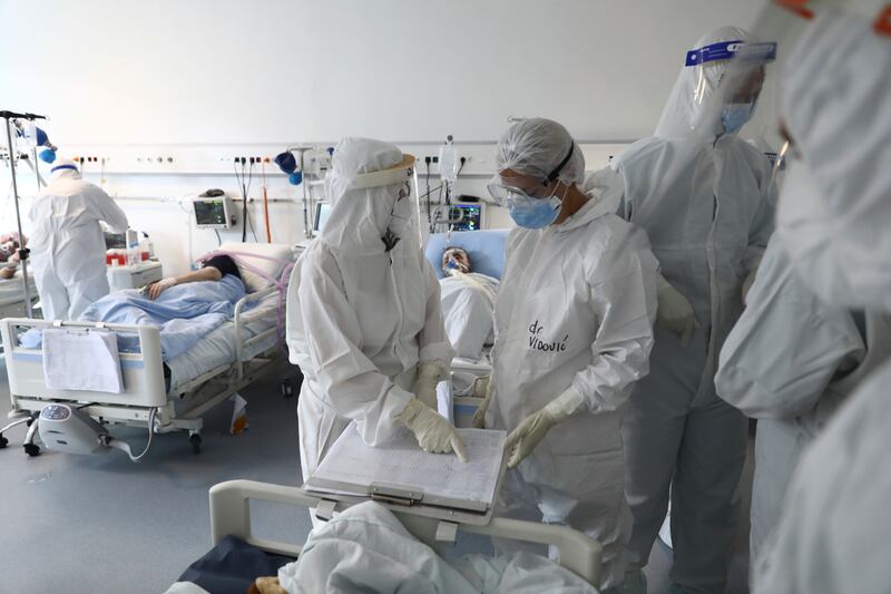 Medical staff in full protective equipment check the charts of patients at the Covid-19 ICU unit of the Dr Abdulah Nakas General Hospital in Sarajevo, Bosnia. AP