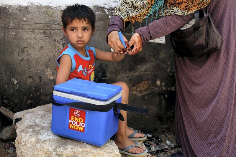 A boy gets his finger marked, after he is administered polio vaccine drops, during an anti-polio campaign, in a low-income neighbourhood in Karachi, Pakistan April 9, 2018. REUTERS/Akhtar Soomro