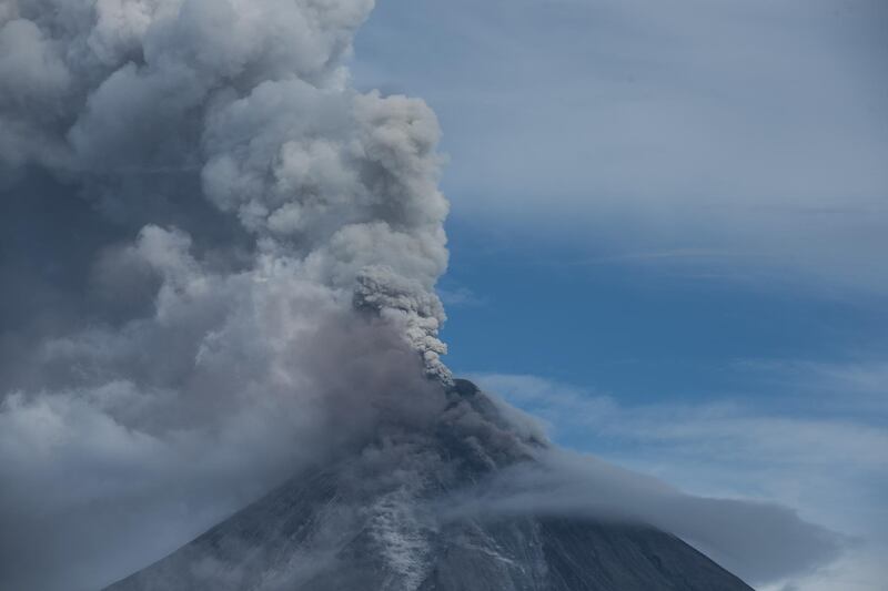 The Mayon volcano is seen spewing ash. Jes Aznar / Getty Images