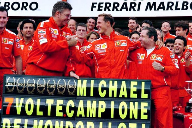 epa03420665 (FILE) German Formula One driver Michael Schumacher (C) celebrates with the Ferrari team after finishing in second place at the Belgian Grand Prix at Francorchamps racing track, 29 August 2004. Schumacher clinched an unprecedented seventh Formula One drivers' title at the Belgian Grand Prix, despite not winning for just the second time in 14 races that season. McLaren's Kimi Raikkonen picked up the victory on the hilly, historic Spa circuit. On 04 October 2012 Schumacher announced that he will retire at the end of the season. This being the second time the 7-season world champion retires. Schumacher's seat at Mercedes will be taken by McLaren's Lewis Hamilton in 2013.  EPA/Oliver Weiken