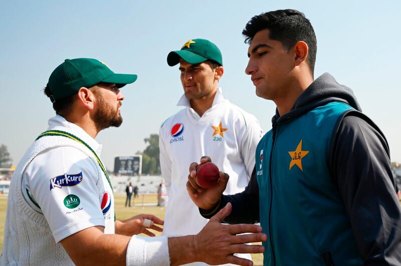 Pakistan's Naseem Shah (R), who yesterday got a hat-trick, holds a ball next to teammates Shaheen Shah Afridi (C) and Yasir Shah (L) at the end of the first cricket Test match between Pakistan and Bangladesh at the Rawalpindi Cricket Stadium in Rawalpindi on February 10, 2020.  Pakistan completed a crushing innings and 44-run victory over Bangladesh on the fourth morning on February 10, taking a 1-0 lead in the two-Test series. / AFP / AAMIR QURESHI
