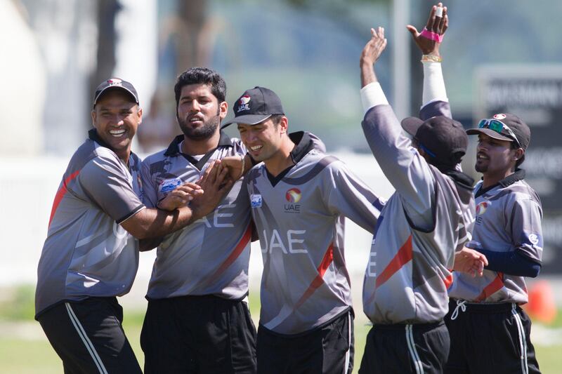 KING CITY, CANADA : August 6, 2013 UAE bowler Muhammad Naveed  (second left) is congratulated by team mates after dismissing   Canada's Nitish Kumar during the one day international  at the Maple Leaf Cricket club in King City, Ontario, Canada ( Chris Young/ The National). For Sports *** Local Caption ***  chy205.jpg