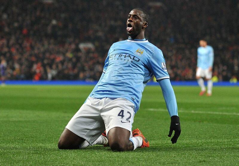 Manchester City midfielder Yaya Touré celebrates after scoring their third goal on Tuesday night. Paul Ellis / AFP / March 25, 2014