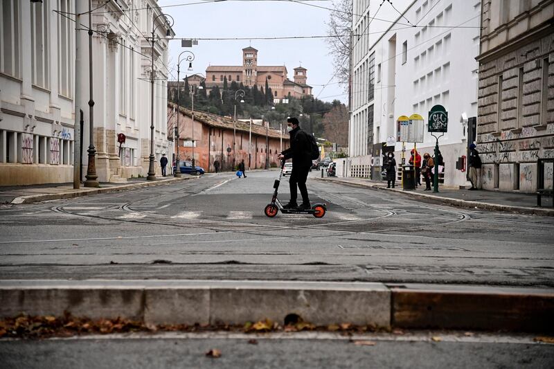 A man on a scooter wearing a face mask in the Trastevere neighborhood in Rome, Italy. EPA