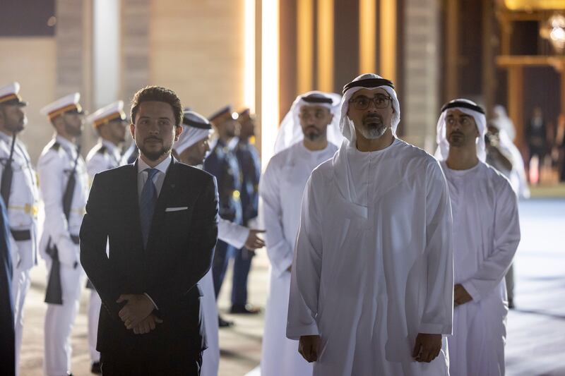 Sheikh Khaled bin Mohamed, Crown Prince of Abu Dhabi and chairman of the Abu Dhabi Executive Council, and Jordan's Crown Prince Hussein bin Abdullah stand at Al Bateen Airport
