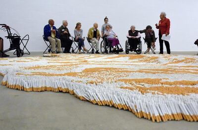 A tour group of dementia patients observe the Xu Bings installation at Lehmbruck Museum