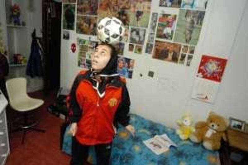 Nilofar Bashir (18) in her room. The women amateur soccer player is preparing for a trainingsession. She plays with her ball while she waits for her friends to call her to come and play. *** Local Caption ***  FILE2785.jpg