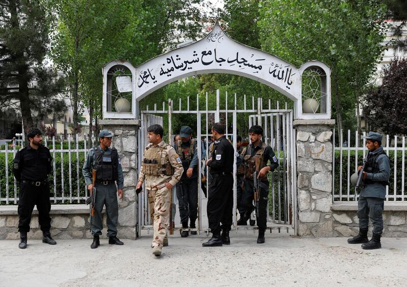 Afghan policemen inspect at the gate of a mosque after a blast in Kabul, Afghanistan June 12, 2020.REUTERS/Mohammad Ismail