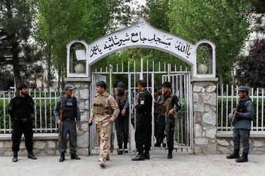Afghan policemen inspect at the gate of a mosque after a blast in Kabul, Afghanistan, on June 12, 2020. Reuters