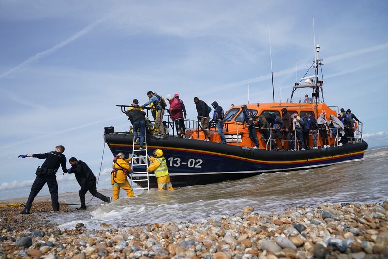 British immigration enforcement officers help migrants from a lifeboat in Dungeness, Kent, on September 13. PA