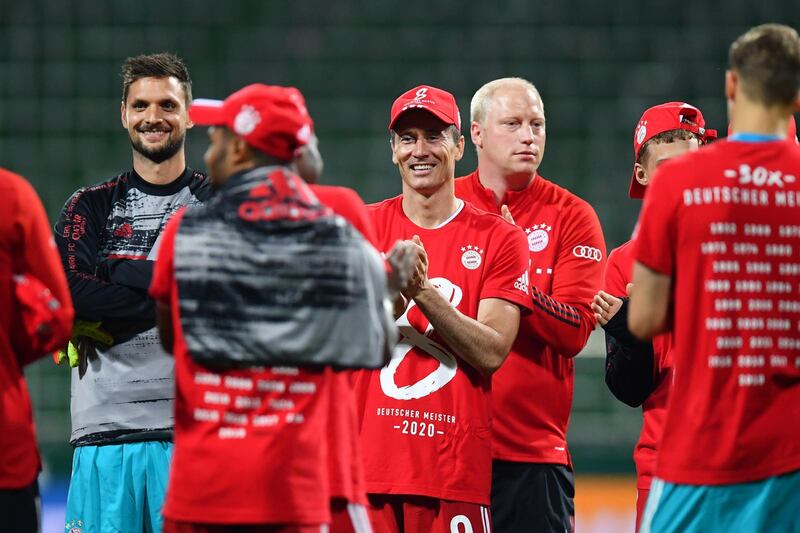 Robert Lewandowski wears a shirt and cap in celebration of securing the Bundesliga title. EPA