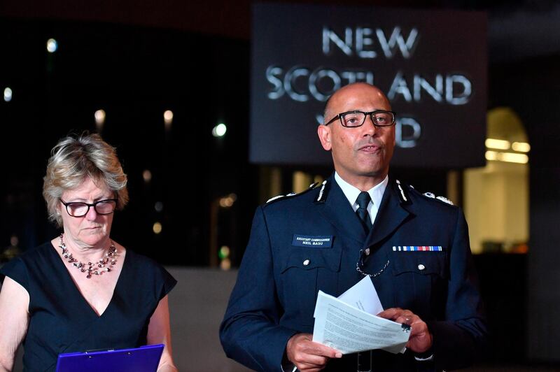 The UK's head of counter-terrorism policing Neil Basu, right, and chief medical officer for England Dame Sally Davies speaking at a news conference at New Scotland Yard in London, Wednesday, July 4, 2018.  British police say couple who are critically ill were exposed to Russian nerve agent Novichok. (John Stillwell/PA via AP)