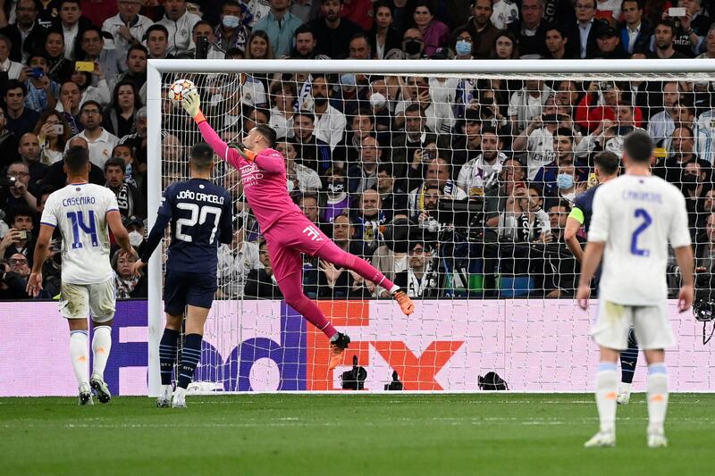 Manchester City goalkeeper Ederson dives for the ball. AFP