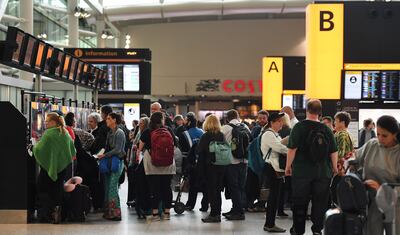 Travellers queue to check-in at Heathrow Airport. EPA