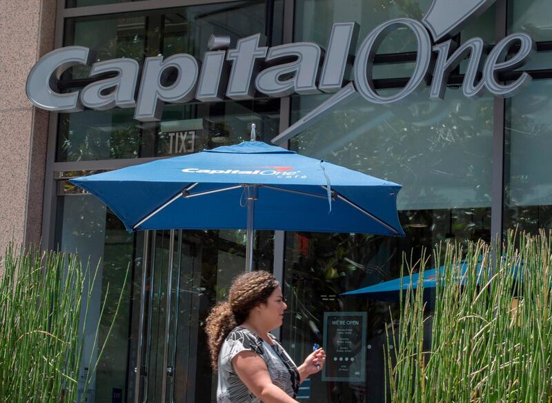 People walk past a Capital One Bank branch in Los Angeles, California on July 31, 2019. A hacker accessed more than 100 million credit card applications with US financial heavyweight Capital One, the firm said on July 29, 2019, in one of the biggest data thefts to hit a financial services company. FBI agents arrested Paige Thompson, 33, a former Seattle technology company software engineer, after she boasted about the data theft on the information sharing site GitHub, authorities said. / AFP / Mark RALSTON
