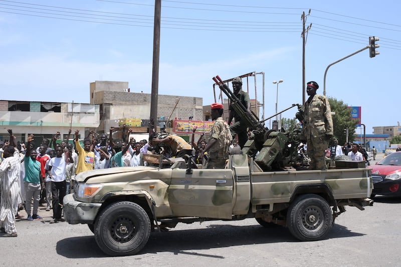 Sudanese greet army soldiers in Port Sudan on April 16. AFP